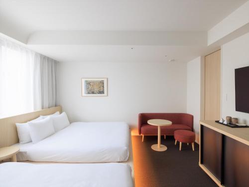 a hotel room with a bed and a table at SOKI KANAZAWA 19th November 2022 OPEN in Kanazawa