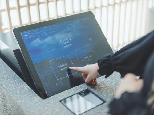 a person pointing at a tablet computer on a table at SOKI Kanazawa in Kanazawa