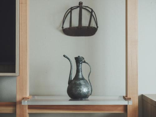 a vase sitting on a shelf in a room at SOKI Kanazawa in Kanazawa
