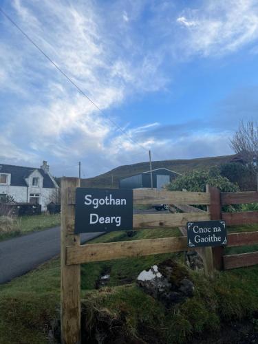 a sign that says spelman derry on the side of a road at Sgothan Dearg in Portree