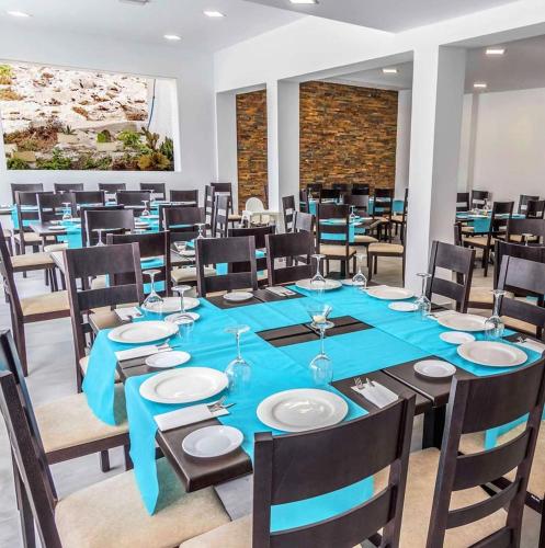 a large dining room with a blue table and chairs at HOSTAL CASA EMILIO in Almería
