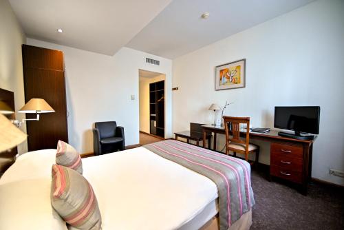 a hotel room with a bed and a desk at Europe Hotel in Yerevan