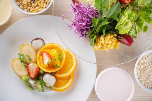 a white plate with a salad and a bowl of food at CHAHARU Hanare Dogo Yumekura in Matsuyama