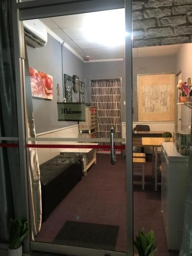 a view of a living room from a glass door at Nusantara Mattwaddien Hostel in Kota Kinabalu