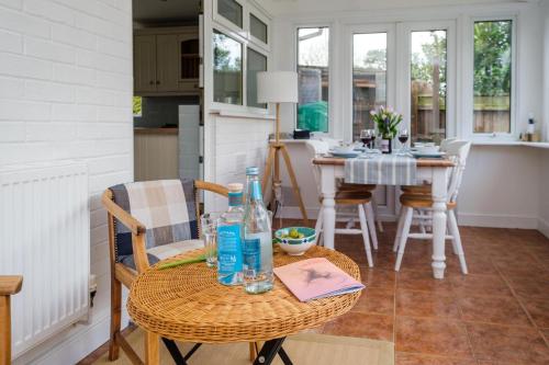 a kitchen and dining room with a table and chairs at The Lodge, Aldringham in Aldringham