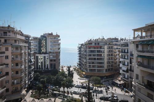 a view of a city with tall buildings and the ocean at Superior One Luxury Apartments in Thessaloniki