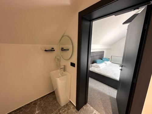 a bathroom with a toilet in a room with a bed at Royal Wood Hotel in Rokytne