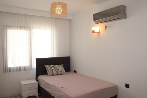 Postel nebo postele na pokoji v ubytování Bella Palm Kuşadası