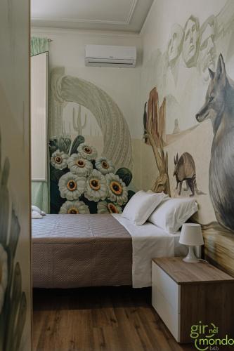 a bedroom with a bed with a mural of a wolf at Giro nel mondo in Catania