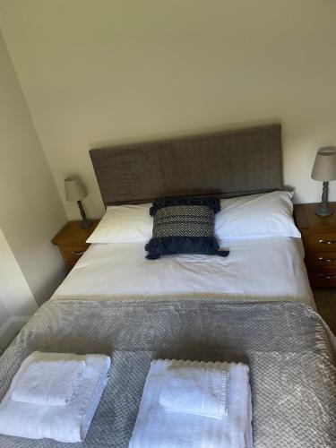 a bedroom with a bed with two towels on it at The Garden House, Necarne, Irvinestown in Irvinestown