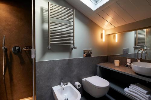 a bathroom with a toilet and a sink and a mirror at Hotel Dei Dragomanni in Venice