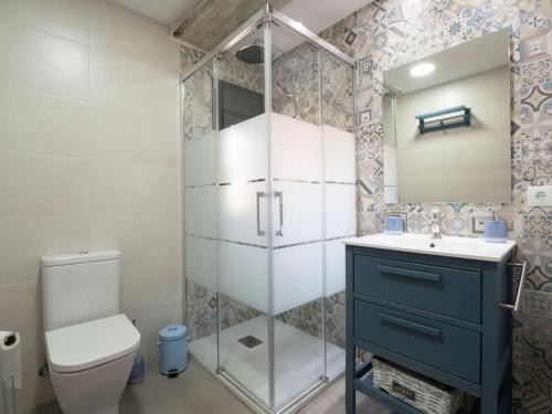 a bathroom with a shower and a sink and a toilet at Casa Rural El Moradel Añon in Añón