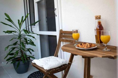 a table with a plate of food and two glasses of orange juice at Mama’s studio in Dubrovnik