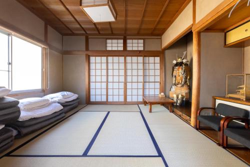 a japanese room with a rug on the floor at Cafe & Guest House Nagonoya in Nagoya