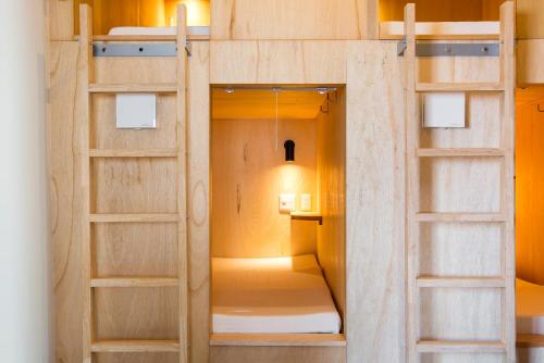 a small room with bunk beds in it at Cafe & Guest House Nagonoya in Nagoya