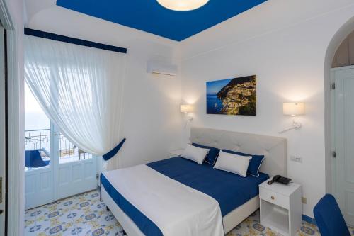 a hotel room with a bed and a window at Locanda Costa D'Amalfi in Amalfi