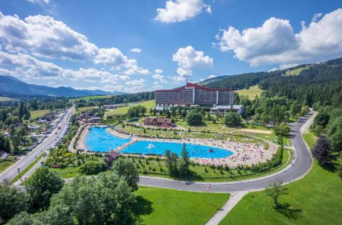 an aerial view of a resort with a large swimming pool at Bachleda Hotel Kasprowy in Zakopane