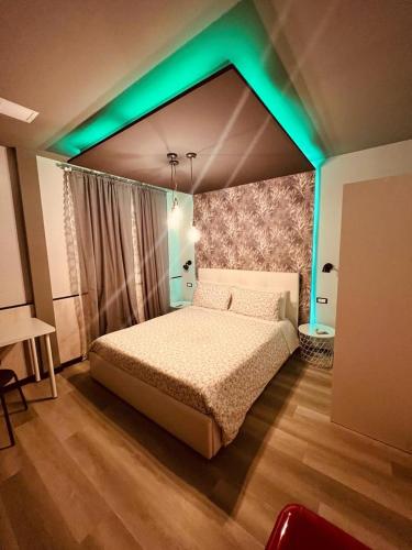 a bedroom with a bed with a green lighting at B&B Marino in Grisolia