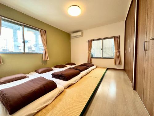 a row of beds in a room with windows at Kotori house - Vacation STAY 05673v in Kyoto