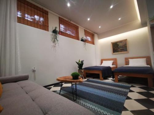 a living room with a couch and two beds at Moonrise Apartment in Mostar