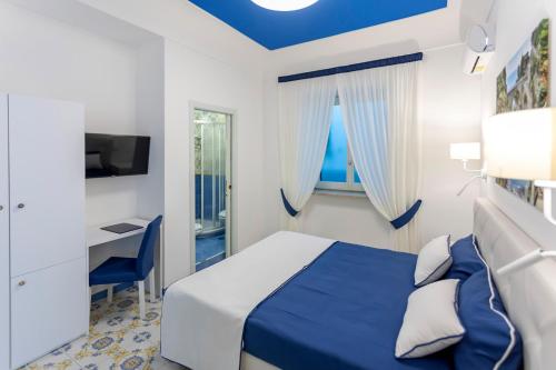 a hotel room with a bed and a desk at Locanda Costa D'Amalfi in Amalfi