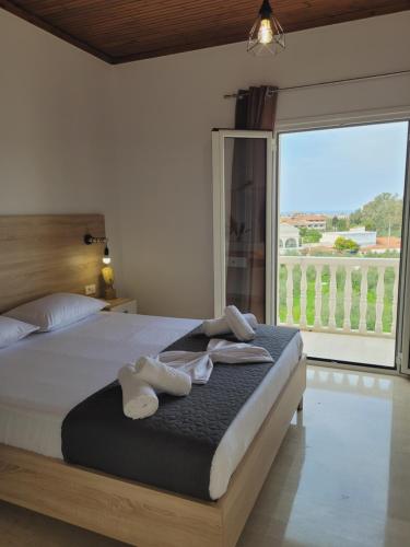 a bedroom with a large bed with towels on it at ROULA STUDIOS in Tsilivi