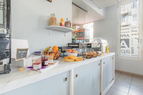 a kitchen with a counter with food on it at Appart'City Classic Nice Acropolis in Nice