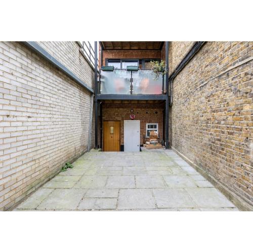 an empty alley with a door in a brick building at Bitcoin Adorabile suite nel cuore del magnifico Chiswick in London