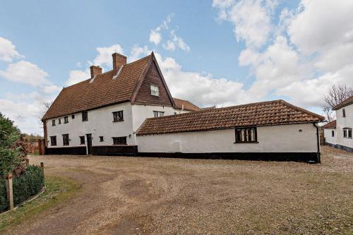 a large white house with a brown roof at The Retreat in Tibenham