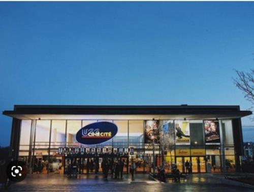 a building with a walmart sign in front of it at Au pied de la Gare de Cergy le haut, centre villes in Cergy