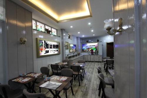 a restaurant with tables and chairs in a room at Kaya Madrid Hotel in Istanbul