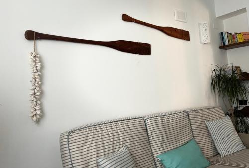 a living room with a couch and two wooden axes on the wall at B&B Residence Eco Del Mare in Palinuro