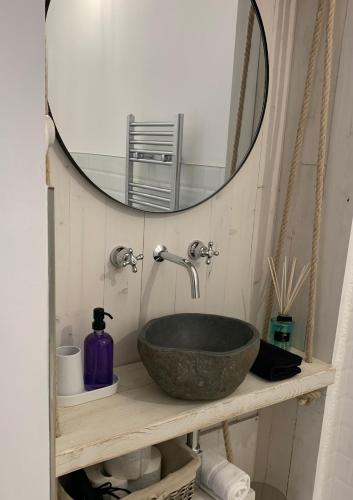 a bathroom with a bowl sink and a mirror at HABITARE Lecce & Salento in Lecce