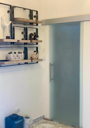 a door in a room with shelves on the wall at HABITARE Lecce & Salento in Lecce