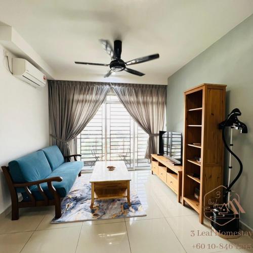 a living room with a blue couch and a table at KULAI IOI MALL D'Putra Suites Near JPO Senai Airport in Kampong Saleng