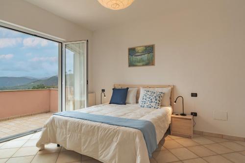 a bedroom with a bed and a large window at Bike e Relax Villa in Bardino Vecchio