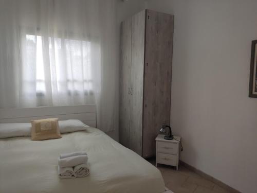 a bedroom with a bed with two towels on it at Holiday home in Galilee in Sheʼar Yashuv