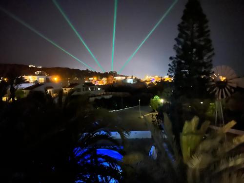 a group of lasers in the sky at night at Lovely cozy one bedroom suite with pool in Protaras