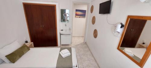 a bathroom with a sink and a toilet and a mirror at Kato Yialos Paros in Parikia