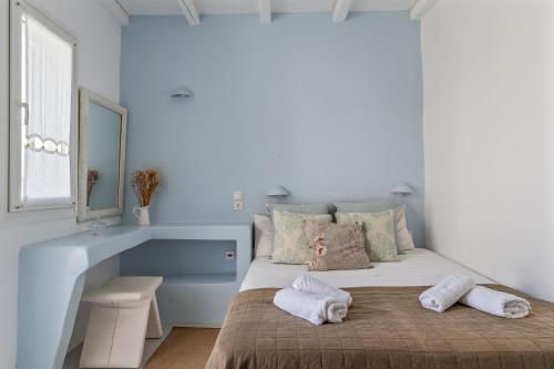 A bed or beds in a room at Ninemia Suites Tinos Superior 102