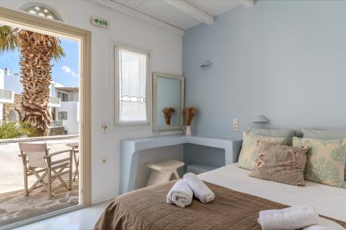 A bed or beds in a room at Ninemia Suites Tinos Superior 102