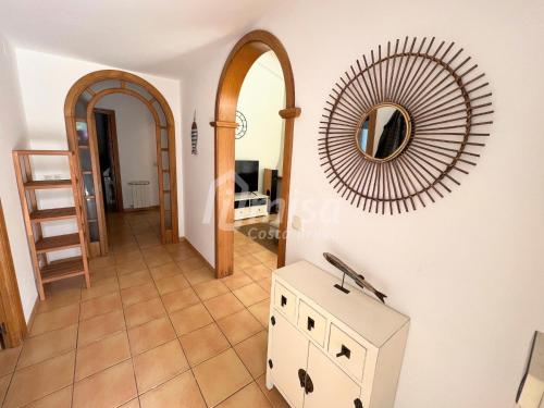 a living room with a mirror on the wall at Villa Brisa Marina in Calonge