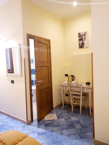 a small room with a table and a door at Hotel Cala Marina in Castellammare del Golfo
