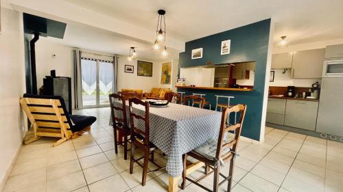 a kitchen and dining room with a table and chairs at Maison spacieuse à deux pas de la plage in Roscanvel