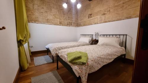 a bedroom with two beds in a room at VallettaCharme - 2 bedrooms Flat in the heart of the city in Valletta