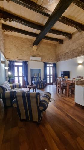 a large living room with couches and a table at VallettaCharme - 2 bedrooms Flat in the heart of the city in Valletta