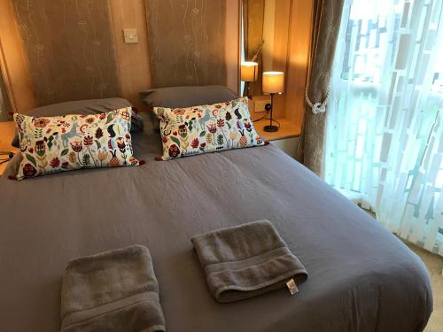a bedroom with a large bed with two pillows at No 70 in Newton Stewart
