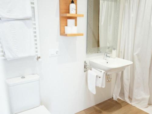 a white bathroom with a sink and a mirror at Apartment 2 Bedrooms 8951 in Bosquemado