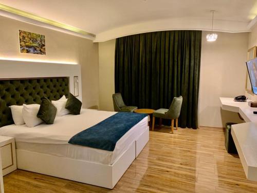 a hotel room with a bed and a desk at Sun Erbil in Erbil