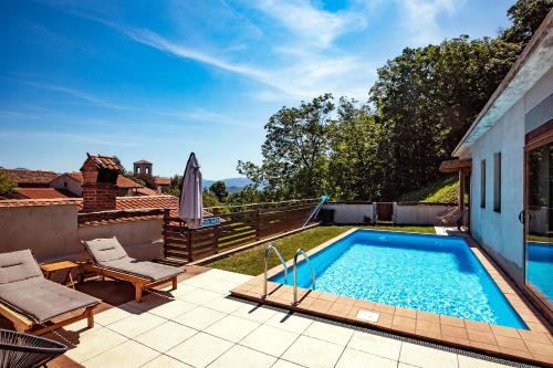 a swimming pool on top of a house at Toncevi Eco Estate in Branik